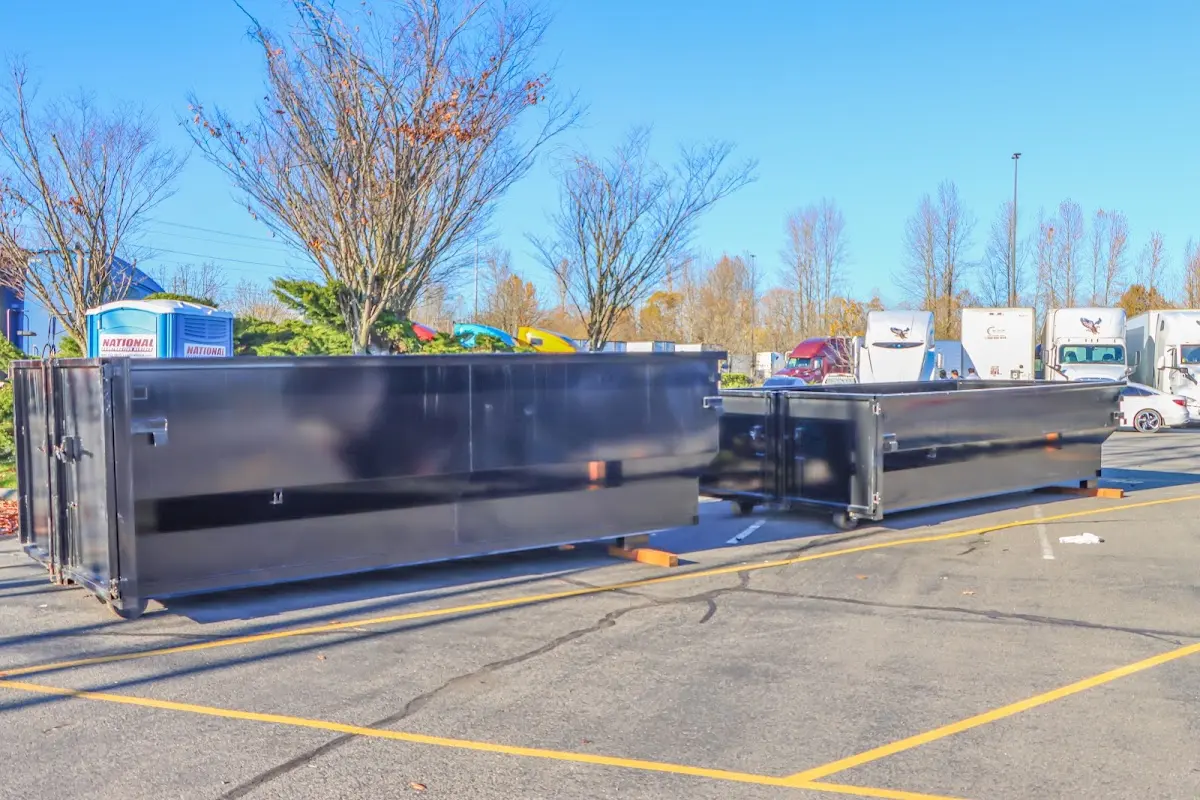 Professional dumpster rental service with roll-off container on residential driveway in Diamond Springs